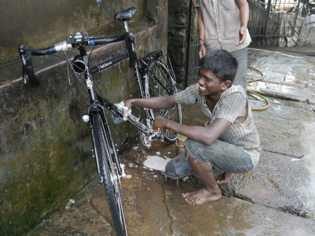 A boy washes a Vivente Bike before the packing process.