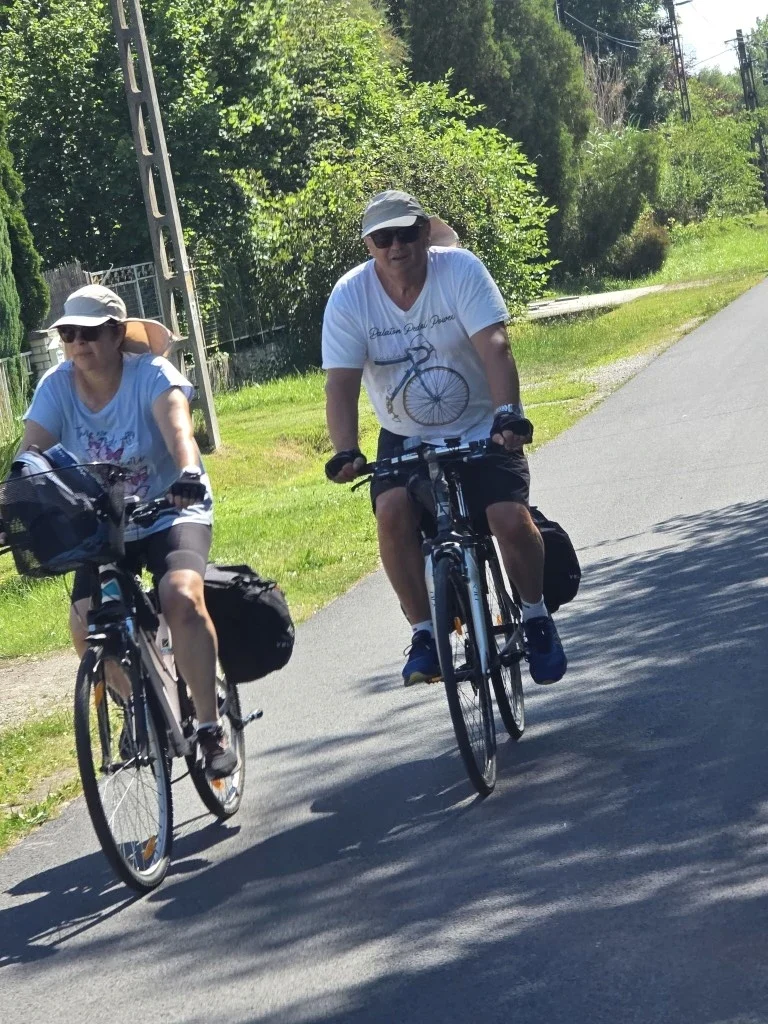 Cyclists riding on the road wearing hats.