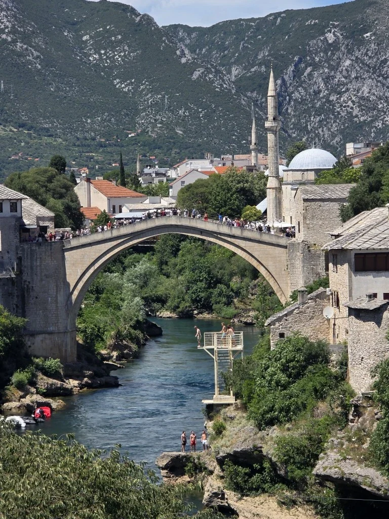 Tourists standing on a bridge in Mostar.